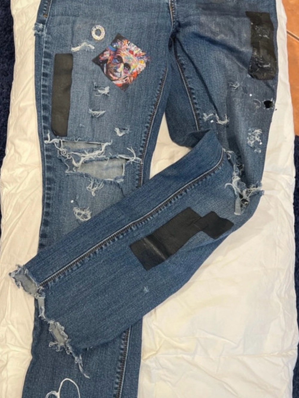 Men's Distressed Blue Denim Jeans with Black Patch Details